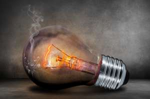 Art work of an electric bulb with lighted filament and smoke coming out of them.